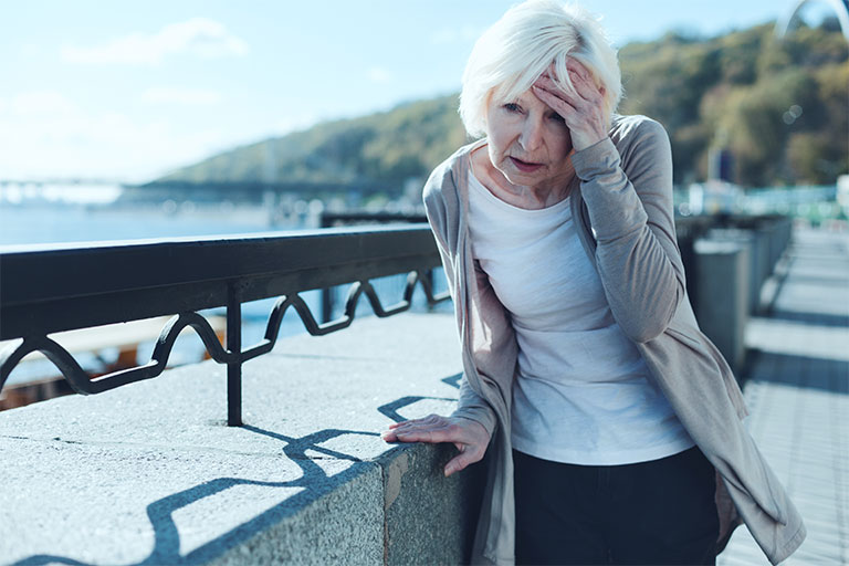 Neck Pain/Headaches/Dizziness Image- Elderly woman holding her head.